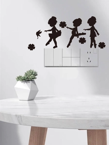 Black silhouette wall sticker featuring three dancing girls and floral accents on a wall