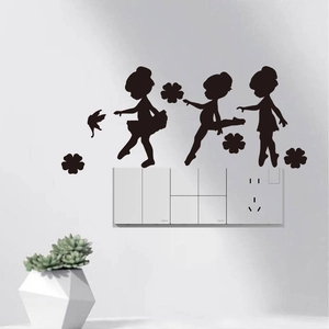 Black silhouette wall stickers of three ballet girls with floral accents on white wall