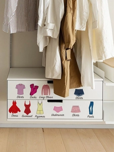 Detail view of colorful wardrobe organization stickers with icons and elegant cursive fonts