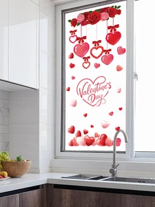 Close-up of Valentine's Day window stickers featuring red roses and heart decorations