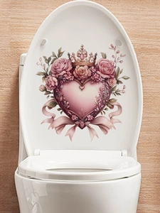 Detailed view of a pink rose heart crown sticker applied on a white toilet lid