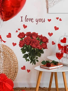 Detail view of red rose and heart wall decals with I love you text on bedroom wall