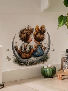 Detail of cute cartoon boy and girl on moon wall sticker in a cozy home setting