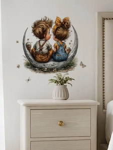 Detailed view of cartoon boy and girl on a crescent moon wall decal in a cozy bedroom