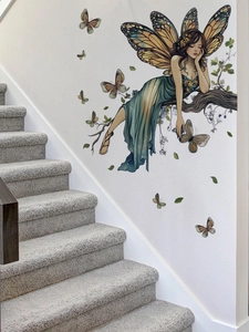 Detail von Schmetterlingsfee-Wandaufkleber auf weißer Wand im künstlerischen Design