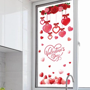Valentine's Day window stickers with red roses and hanging hearts on a glass kitchen door