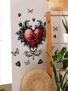 Detailed view of red rose heart wall sticker with green leaves and butterflies on white wall