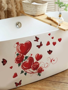 Detail of red heart and rose wall stickers applied on a white bathtub in a cozy setting