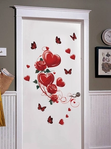 Detailed view of red 3D hearts, roses and butterflies wall stickers on a white door