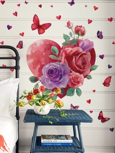 Detail of red heart wall sticker with roses and butterflies on a white wooden wall