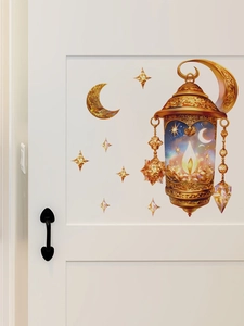 Detail of Ramadan gold lantern and crescent moon PVC wall sticker on a white door