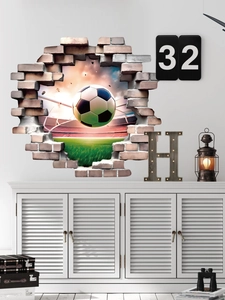 Macro detail of a 3D soccer wall sticker featuring a ball breaking through a brick wall effect