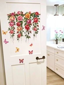 Détail de panier de roses roses et stickers papillons sur une porte blanche