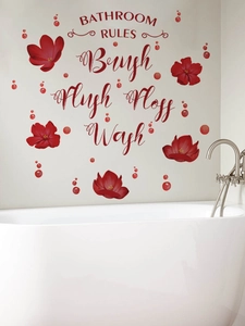 Detail showing Bathroom Rules wall decal with red flowers on a white tile wall