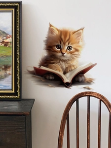 Detailed 3D wall sticker featuring a cute ginger kitten resting on an open book in a room
