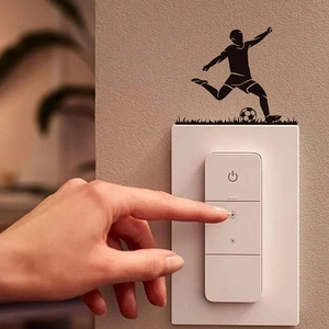 Soccer player silhouette wall sticker decorating a smart touch switch on a white wall