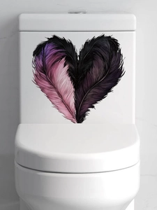 Detail of pink and black feather heart sticker applied on a white toilet water tank