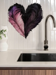 Detail of heart feather wall sticker with pink and purple textures on kitchen tile wall