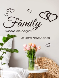 Detail of Family quote wall sticker with black lettering and heart patterns in a cozy room