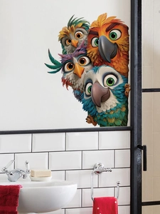 Detail showing 3D cartoon birds wall stickers peering from a black door frame in a bathroom