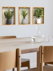 Three-piece wall-mounted wood frames with green potted plants and built-in lighting