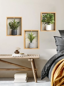 Detailed view of three wooden wall frames with lifelike faux plants and LED lighting