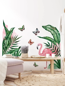 Detailed tropical wall decal set with green palm leaves and pink flamingo on white wall