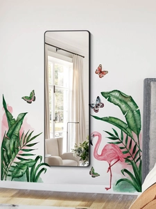 Detail of flamingo and tropical leaf wall stickers on white wall near rectangular mirror