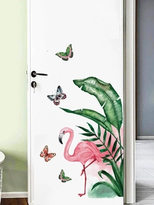 Detail of pink flamingo and tropical palm leaves wall sticker on white door panel