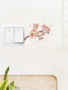 Detail of pink watercolor cherry blossom wall stickers next to a white light switch