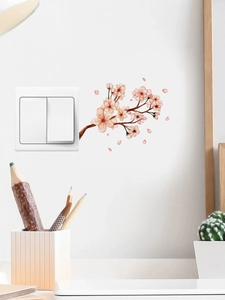 Macro detail of cherry blossom wall sticker applied on a white light switch surface
