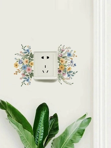 Detailed view of colorful floral wall decals around a standard square power socket