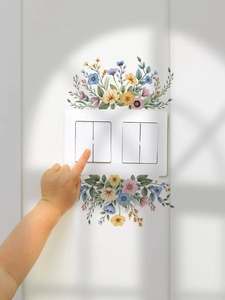 Detail view of watercolor wildflower wall stickers surrounding a white light switch cover