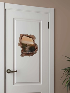 Detail of 3D cracked wall sticker showing a sunset beach landscape on a white door
