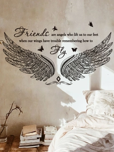 Detail of inspirational wall sticker with elegant wings and butterfly motifs over a bed