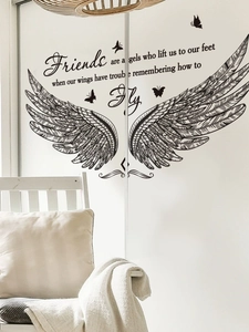Detail of PVC wall sticker with black wings, butterflies, and friendship quote on white wall