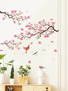 Detailed view of cherry blossom branch wall decals with colorful birds on a white wall