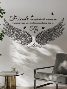 Detail of wall decal showing intricate wings and friendship quote on a textured wall