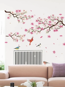 Detailed view of watercolor cherry blossom wall stickers with colorful birds on a white wall