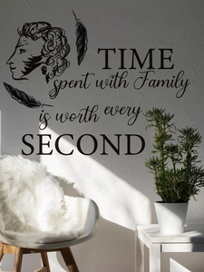 Detail view of Family Time quote wall decal with elegant silhouettes and feathers on a white wall