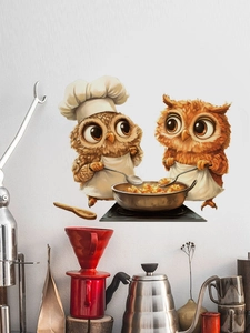 Macro detail of cartoon chef owl wall sticker on a white textured kitchen wall