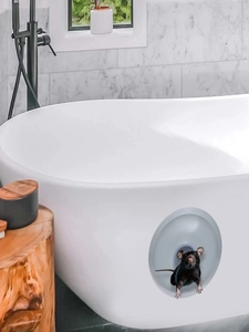 Macro detail of waterproof 3D mouse hole wall sticker on modern bathroom tile surface