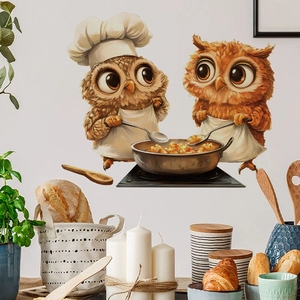 Cute couple owl chef wall stickers in a warm brown kitchen setting with a rustic frying pan