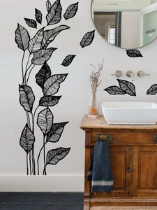 Detail of black leaf wall stickers with fine hand-drawn lines on a white wall decor