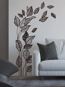 Detail of minimalist black leaf wall decal applied on a modern white living room wall