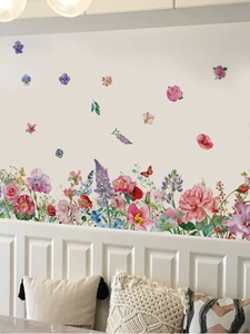 Detail of watercolor flower wall stickers with butterflies on a white paneled home wall