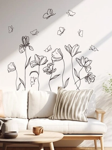 Living room setup with minimalist black line art flower and butterfly wall stickers