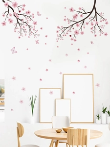 Detail view of pink cherry blossom wall stickers with butterflies on a white wall