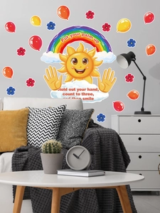 Cartoon rainbow sun wall decals in a cozy living room setting over a modern sofa
