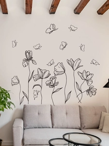 Minimalist black line art flower and butterfly wall stickers in a modern living room